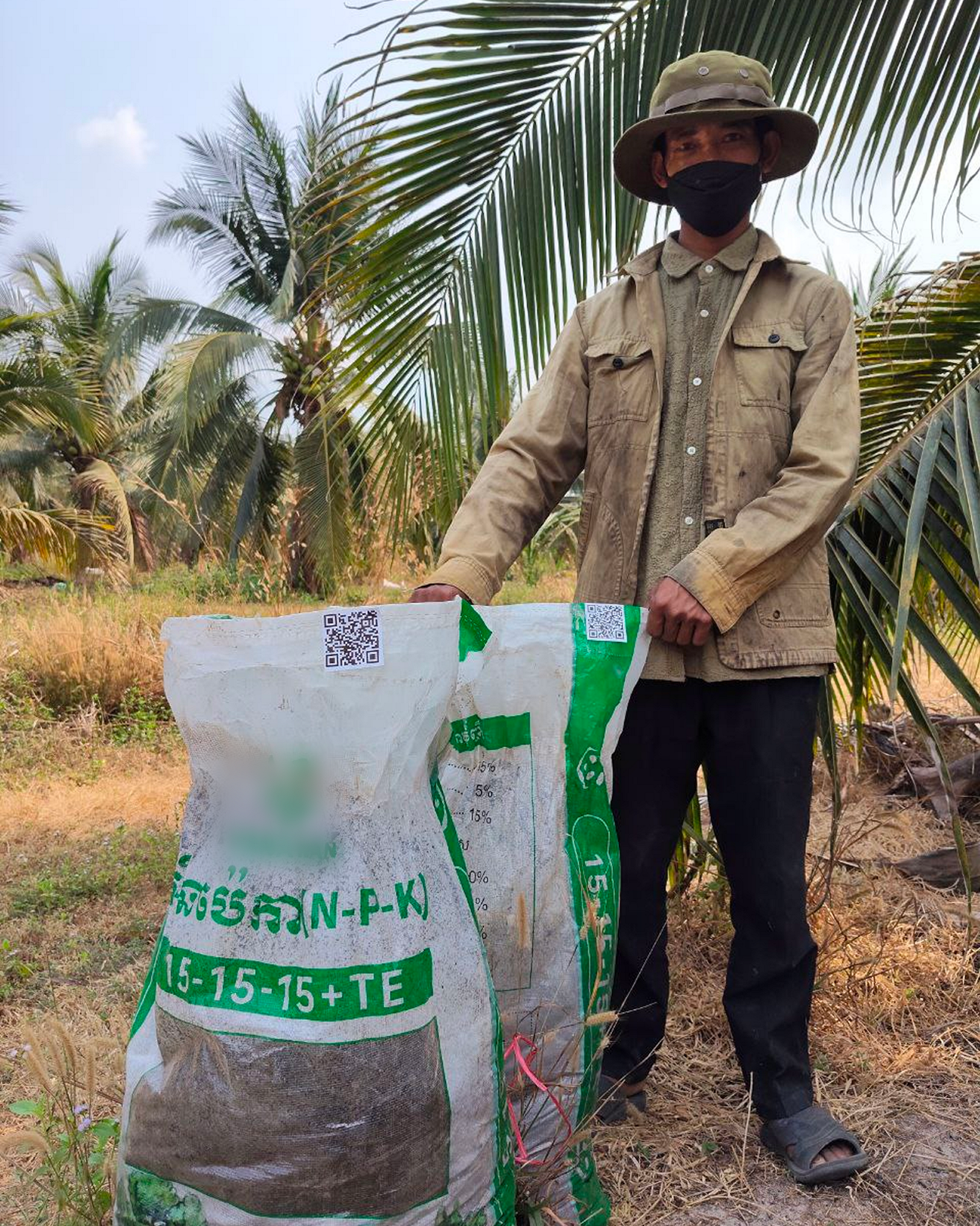 Farmer using fertiliser with a QR code for traceability